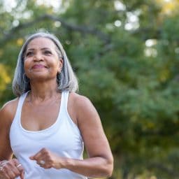 Woman going for a brisk walk in nature.