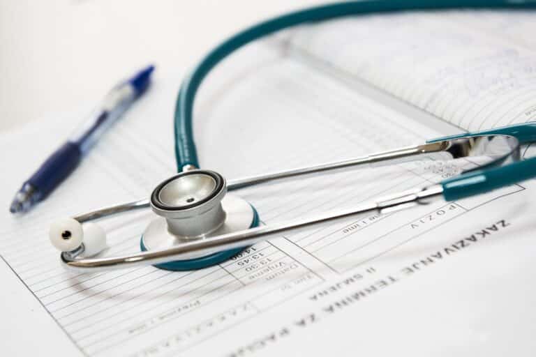 Close up of a stethoscope on top of doctor's notes.