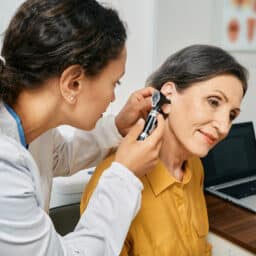 Woman getting her ears examined by a hearing specialist.