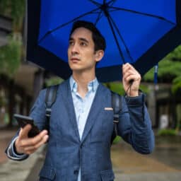 Man with hearing aid in the rain